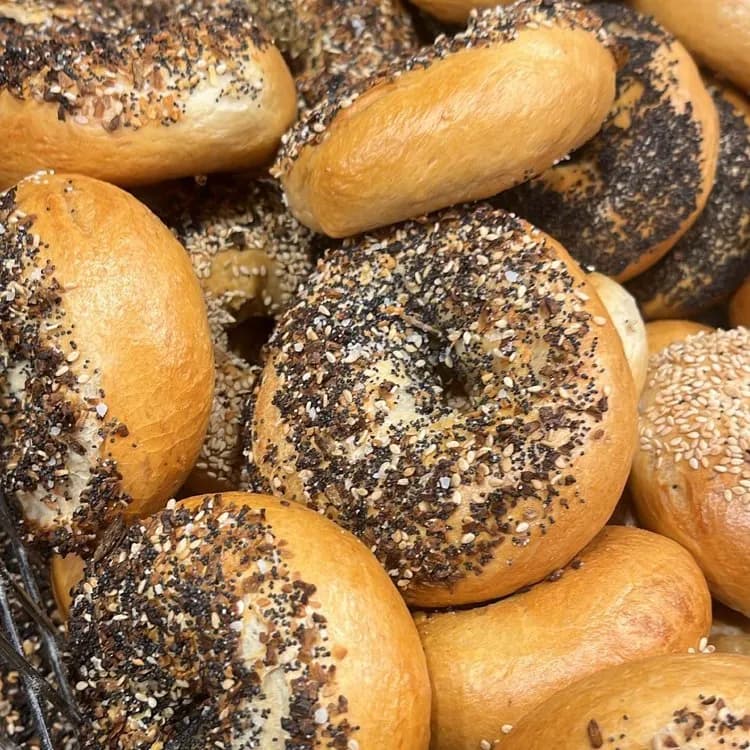 A pile of poppy and sesame Straussie’s bagels